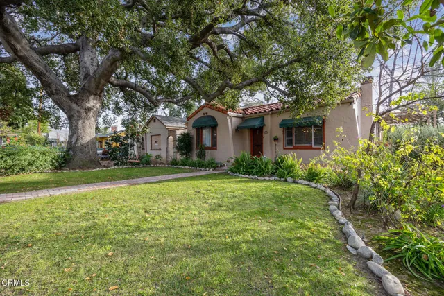 a front view of house with yard and green space