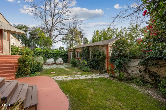 a view of a garden with a house