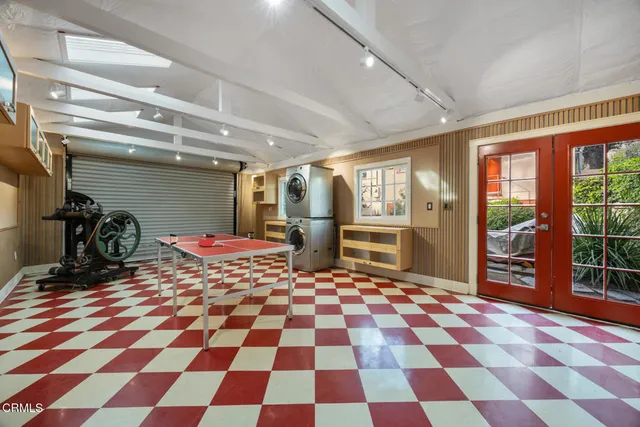 a view of a backyard with plants and large trees