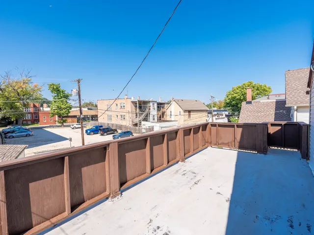 a kitchen with stainless steel appliances kitchen island granite countertop a table chairs in it