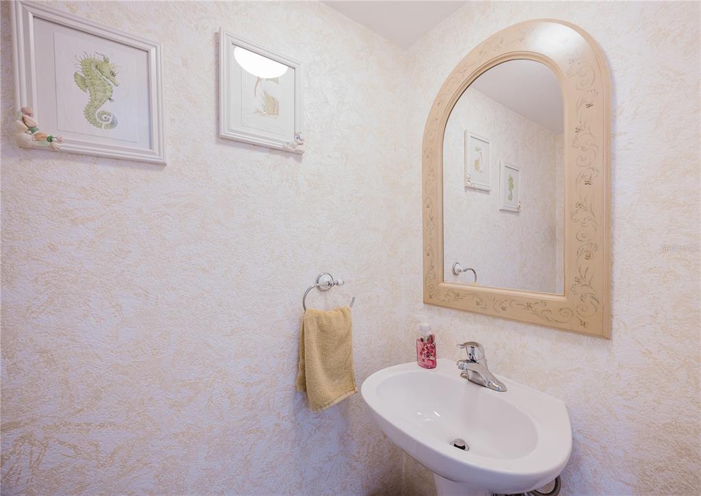 26282 Rampart Boulevard, Unit 204 Punta Gorda, FL 33983 - Photo 18 of 34 a bathroom with a sink and a mirror