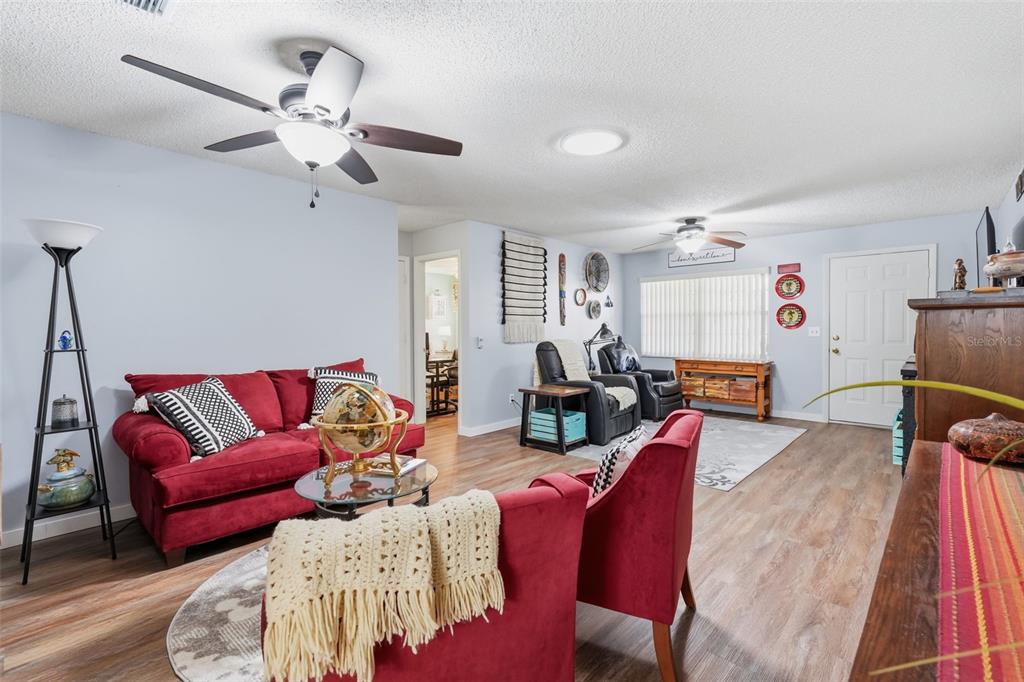 8556 Southwest 90th Lane, Unit F Ocala, FL 34481 - Photo 11 of 34 a living room with furniture a couch and a chandelier