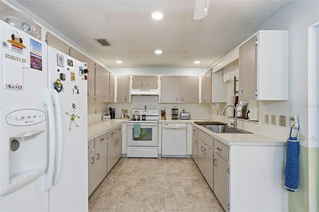 8556 Southwest 90th Lane, Unit F Ocala, FL 34481 - Photo 12 of 34 a kitchen with white cabinets and white appliances