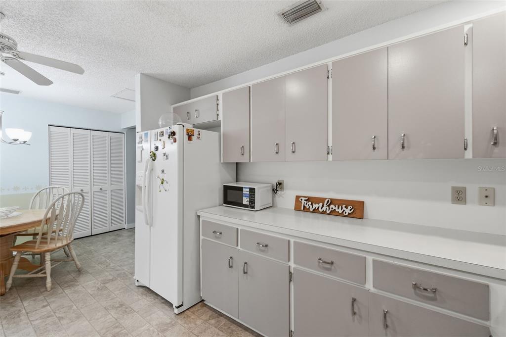 8556 Southwest 90th Lane, Unit F Ocala, FL 34481 - Photo 14 of 34 a view of kitchen with refrigerator and cabinets