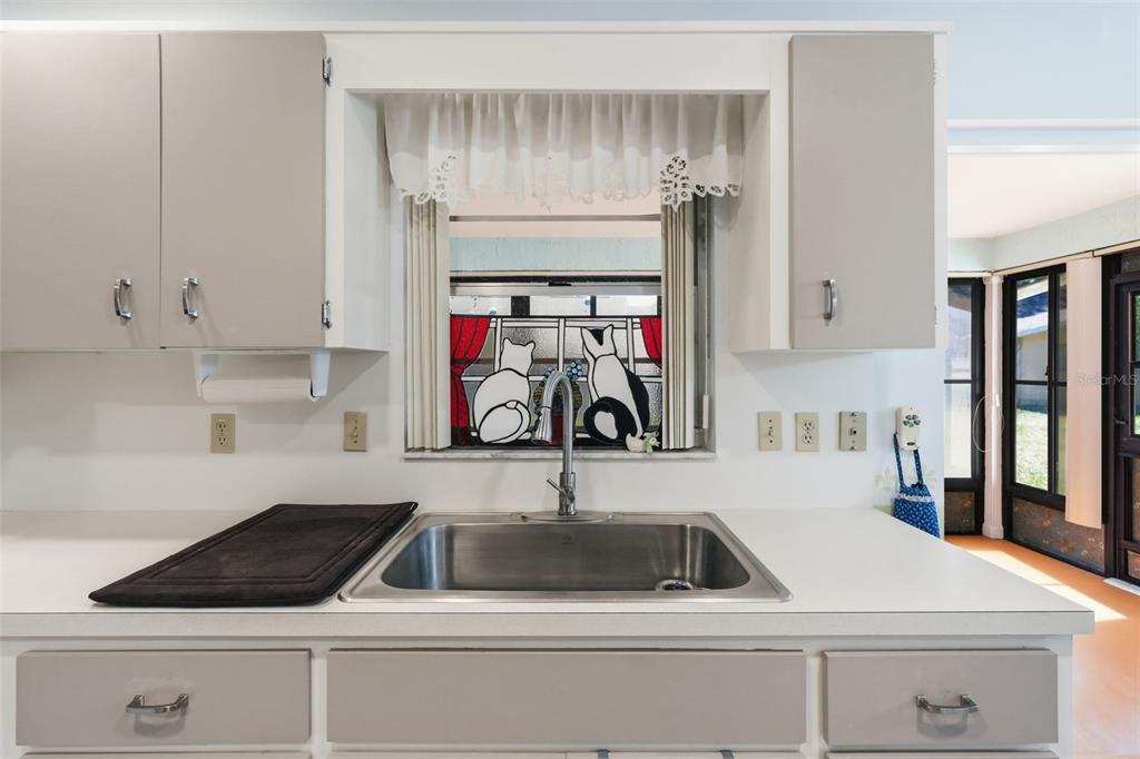 8556 Southwest 90th Lane, Unit F Ocala, FL 34481 - Photo 15 of 34 a kitchen with white cabinets and sink