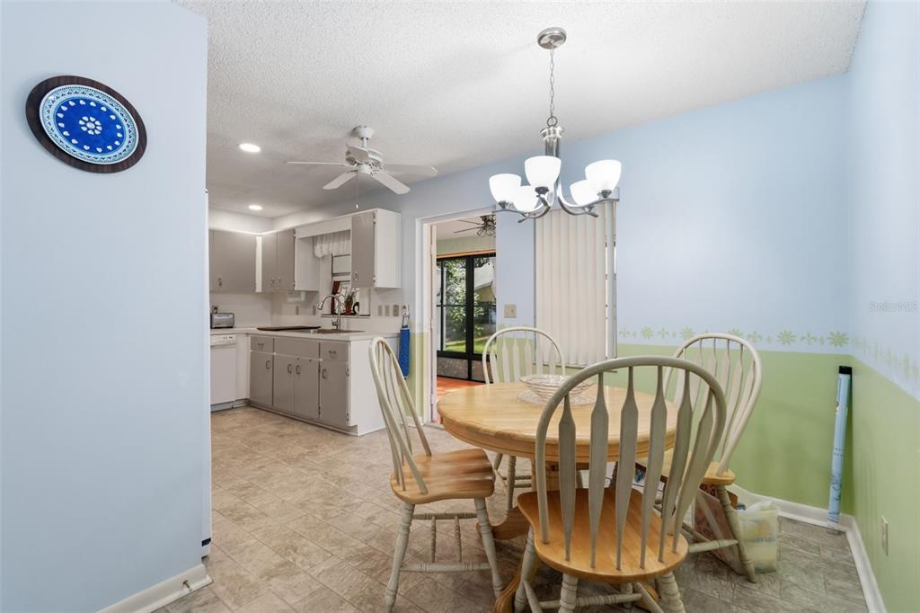 8556 Southwest 90th Lane, Unit F Ocala, FL 34481 - Photo 16 of 34 a view of a dining room with furniture and a chandelier