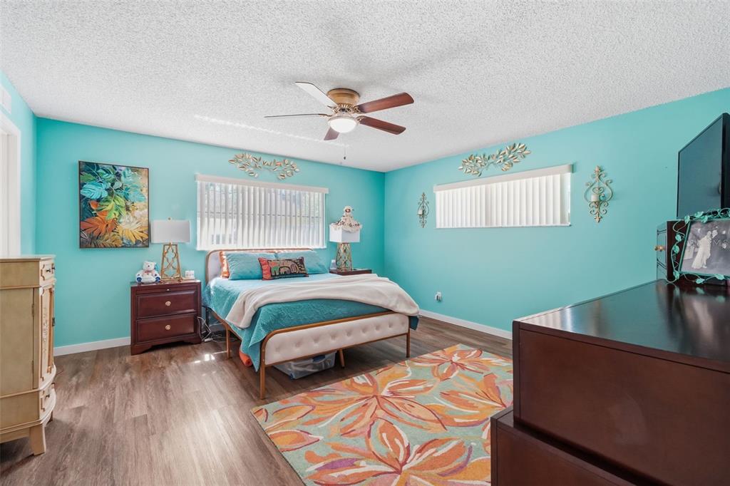 8556 Southwest 90th Lane, Unit F Ocala, FL 34481 - Photo 18 of 34 a bedroom with a bed and a dresser next to a window