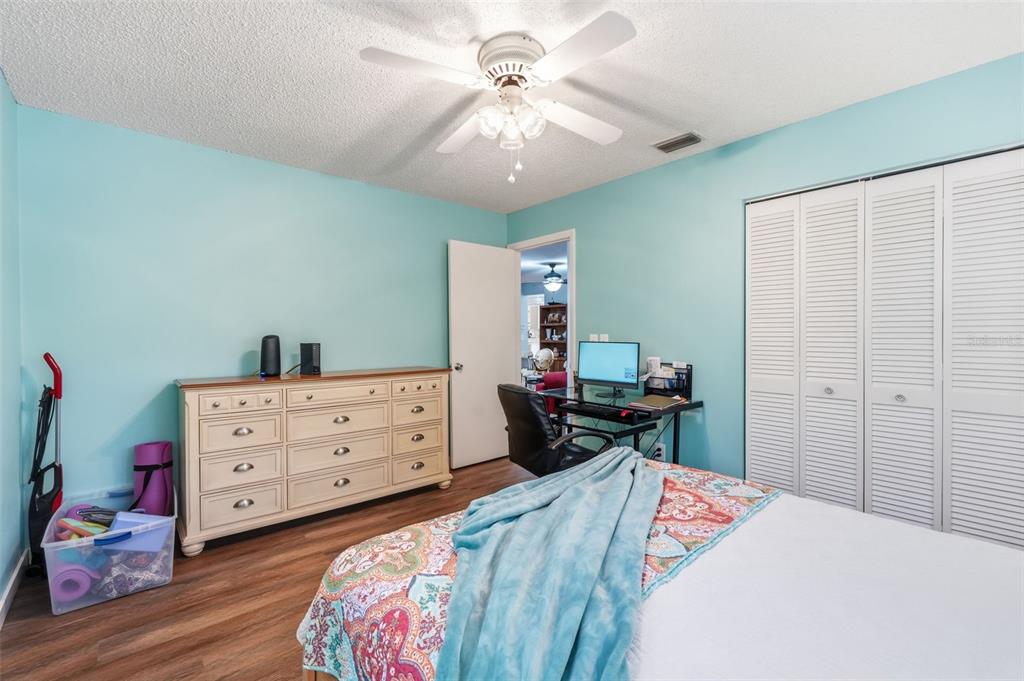 8556 Southwest 90th Lane, Unit F Ocala, FL 34481 - Photo 25 of 34 a bedroom with a bed and a dresser