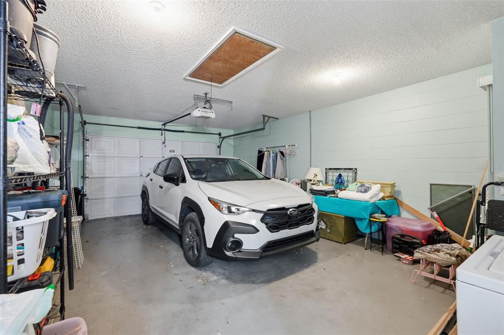 8556 Southwest 90th Lane, Unit F Ocala, FL 34481 - Photo 26 of 34 a utility room with a bed and a chandelier