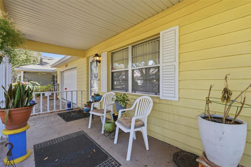 8556 Southwest 90th Lane, Unit F Ocala, FL 34481 - Photo 4 of 34 a view of a patio with table and chairs and potted plants