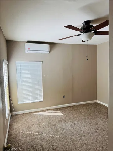 an empty room with a ceiling fan and closet