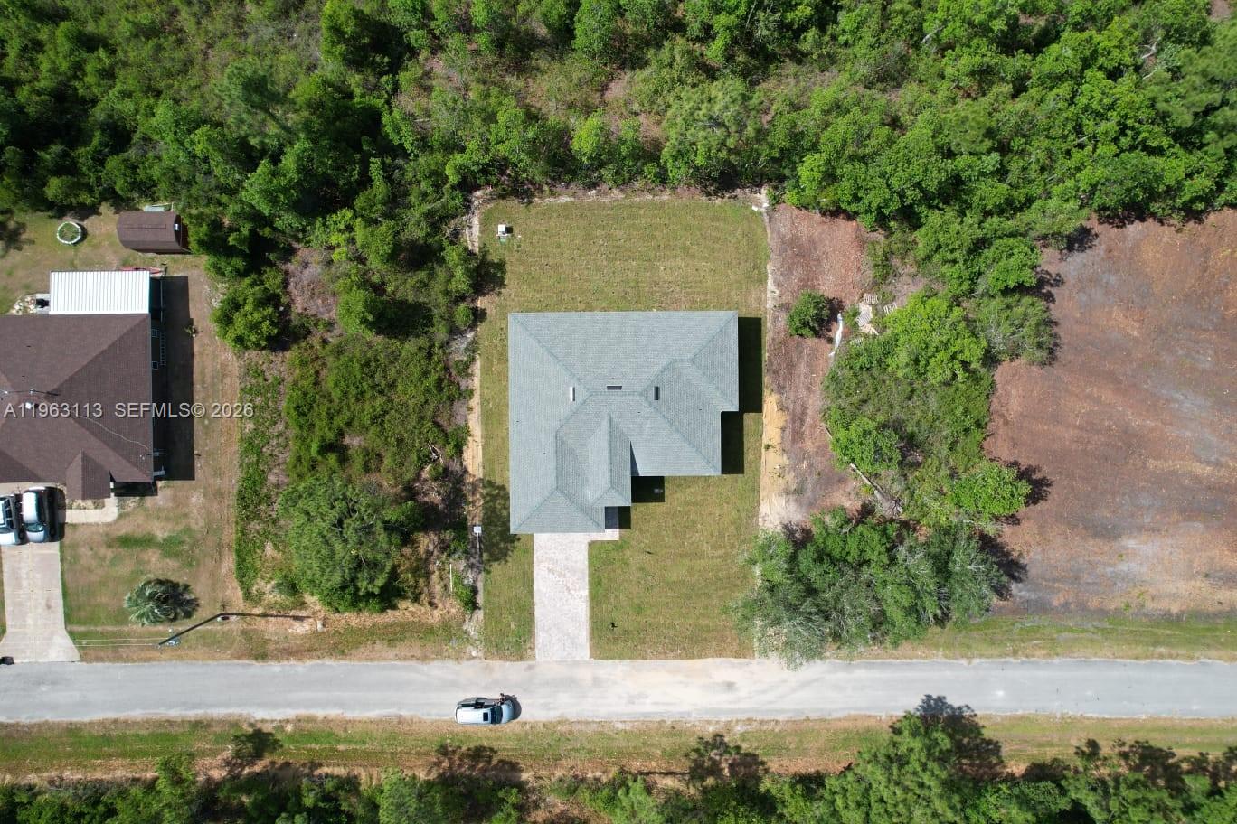8001 Leonardo Street Sebring, FL 33872 - Photo 23 of 27 an aerial view of a house with yard and lake view