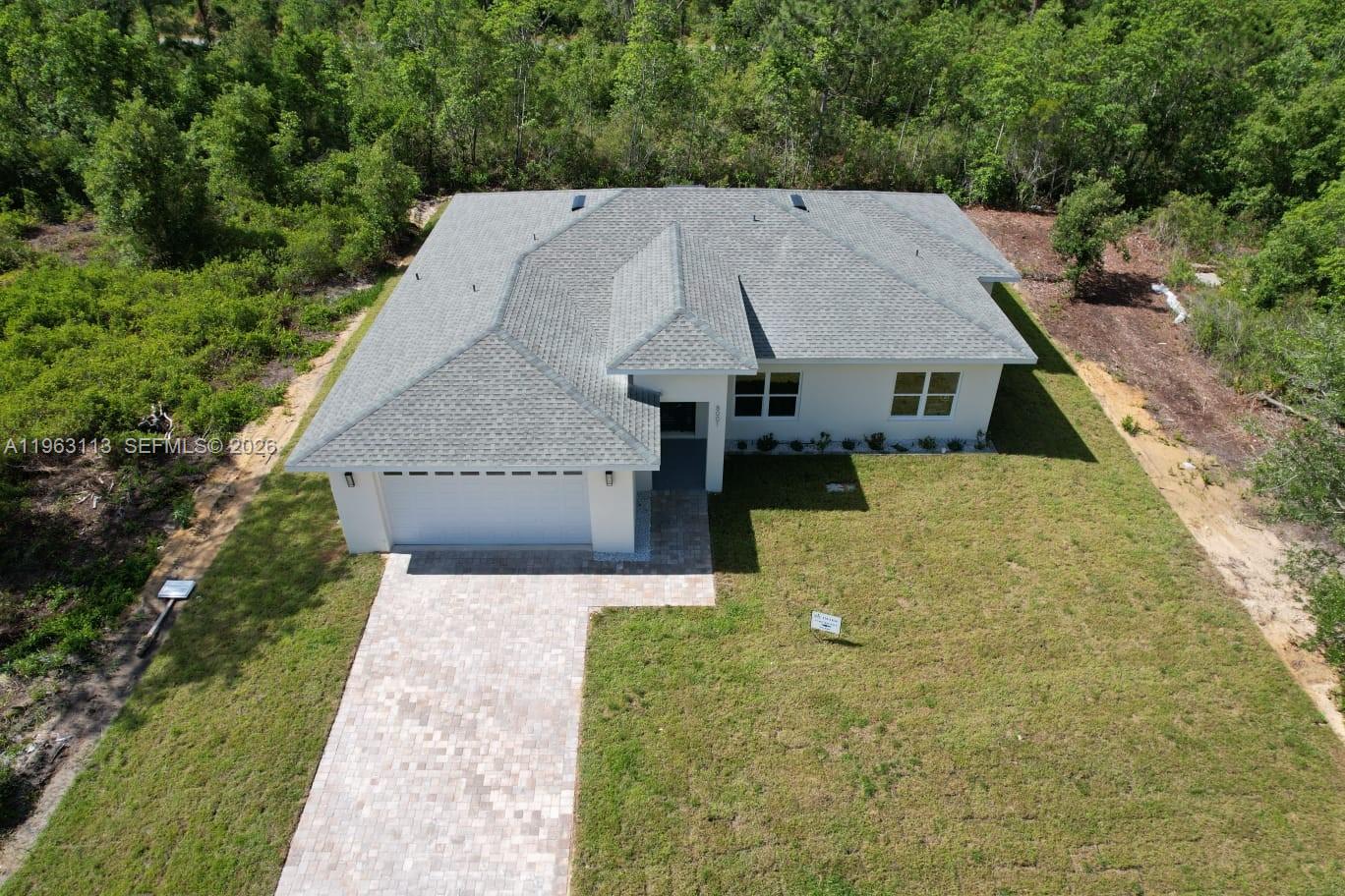 8001 Leonardo Street Sebring, FL 33872 - Photo 24 of 27 an aerial view of a house with a yard