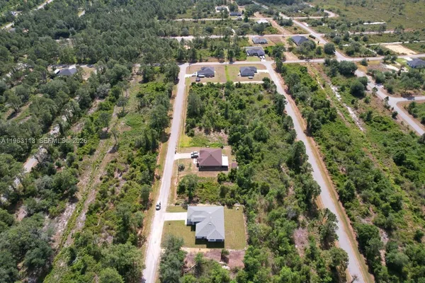 an aerial view of house with yard and swimming pool