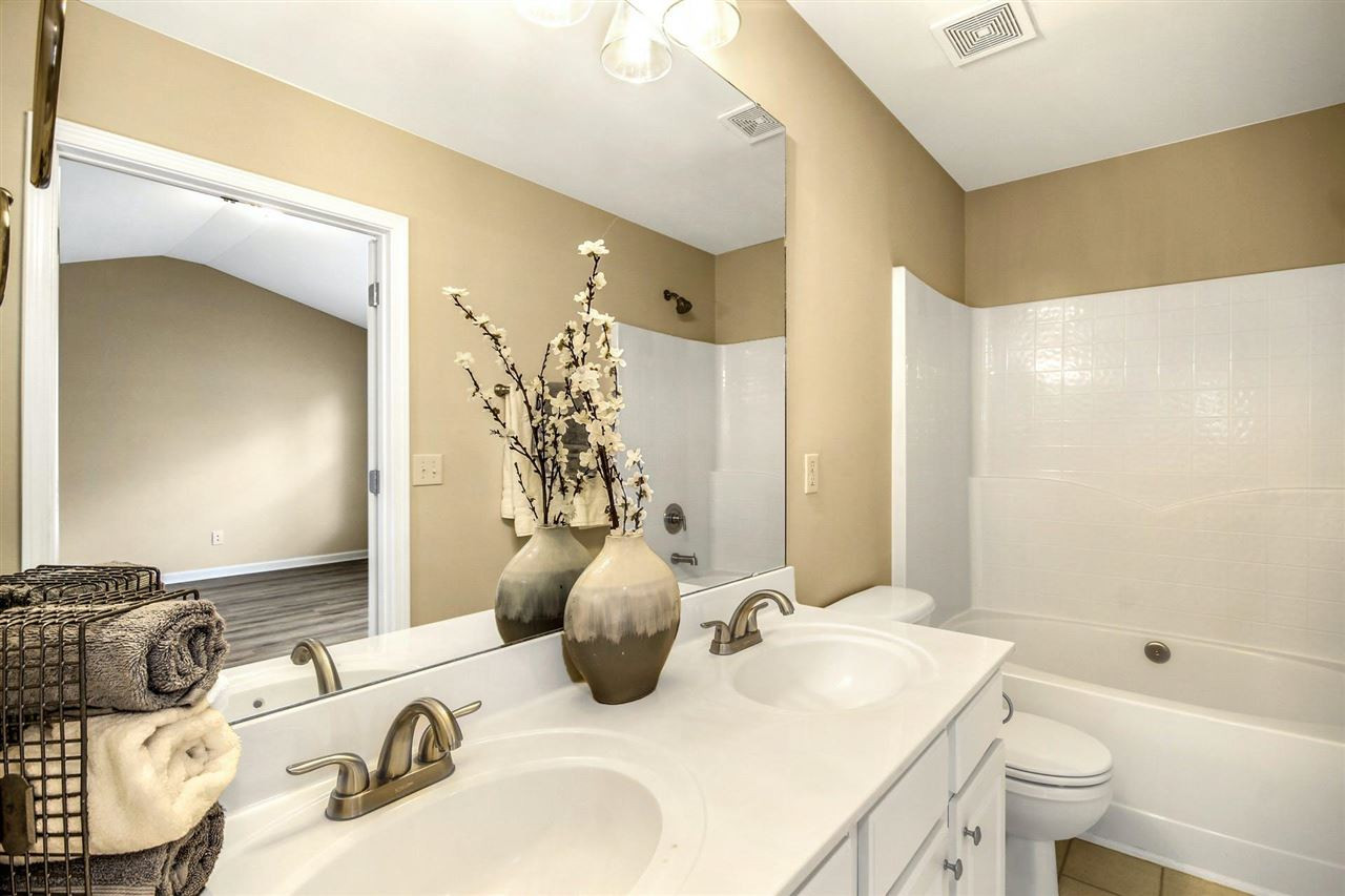 5527 Golden Arrow Lane Raleigh, NC 27613 - Photo 16 of 29 Large vanity and new flooring and new fixtures in full bath in bedroom #1