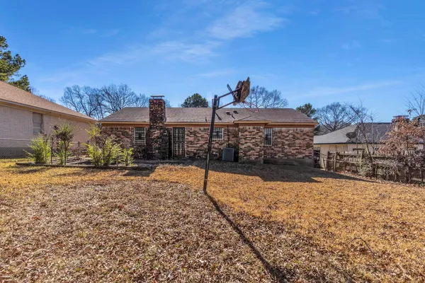 a view of a yard with a building in the background