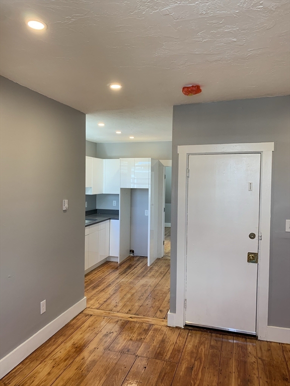8 Beethoven Street, Unit 3L Boston, MA 02119 - Photo 6 of 9 a view of a kitchen with a sink and a refrigerator