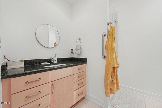 103 West Main Street, Unit 305 Durham, NC 27701 - Photo 18 of 25 a bathroom with a granite countertop sink and a mirror