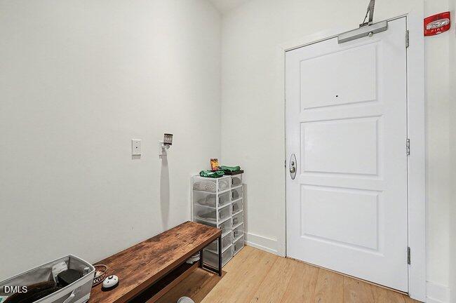 103 West Main Street, Unit 305 Durham, NC 27701 - Photo 4 of 25 an empty room with wooden floor