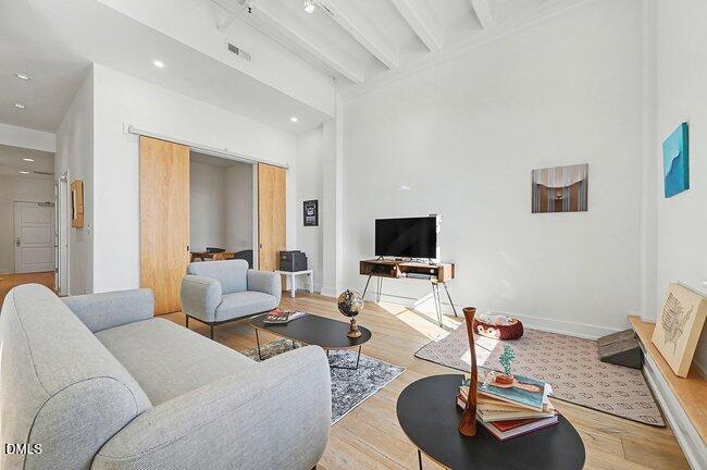 103 West Main Street, Unit 305 Durham, NC 27701 - Photo 7 of 25 a living room with furniture and a flat screen tv