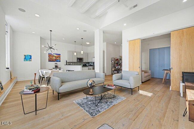 103 West Main Street, Unit 305 Durham, NC 27701 - Photo 8 of 25 a living room with furniture and a wooden floor