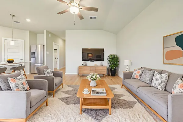 a living room with furniture and wooden floor