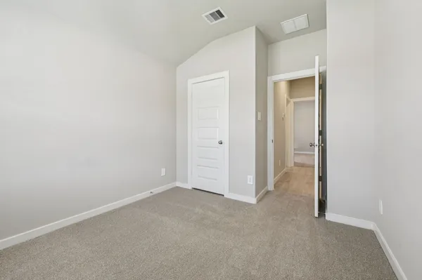 an empty room with closet area