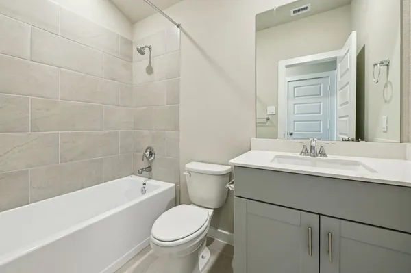 a bathroom with a sink toilet vanity and bathtub
