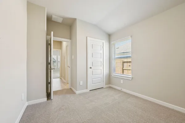 an empty room with windows and closet