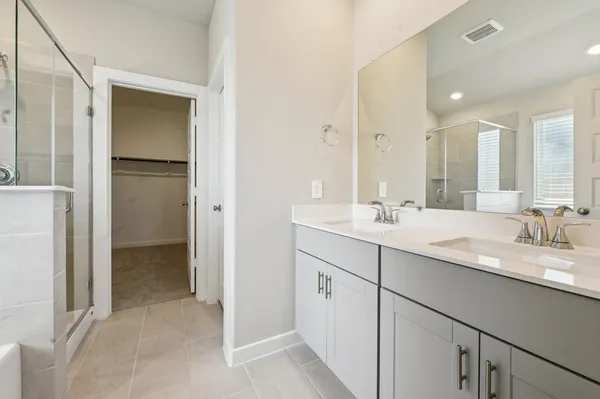 a bathroom with a double vanity sink and mirror