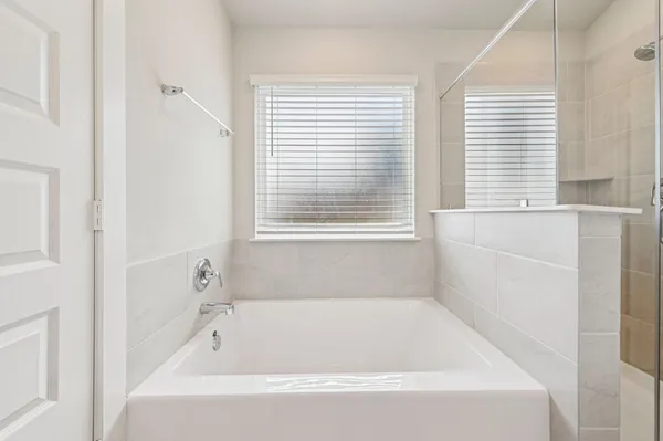 a white bath tub sitting next to a window