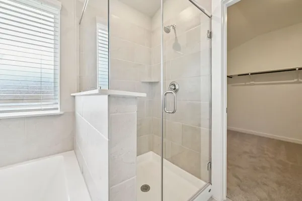 a bathroom with a glass shower door