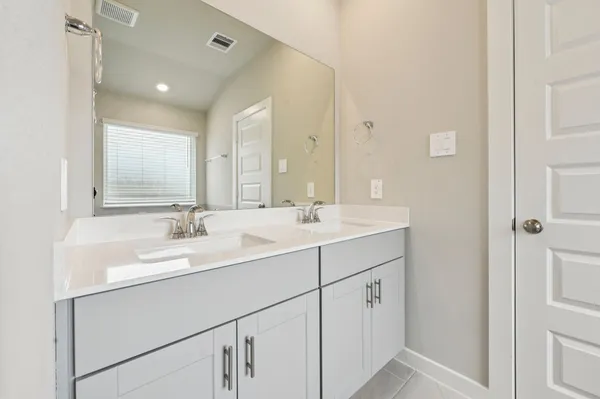 a bathroom with 2 sink and a mirror