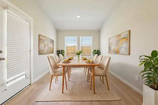 a view of a dining room with furniture window and wooden floor