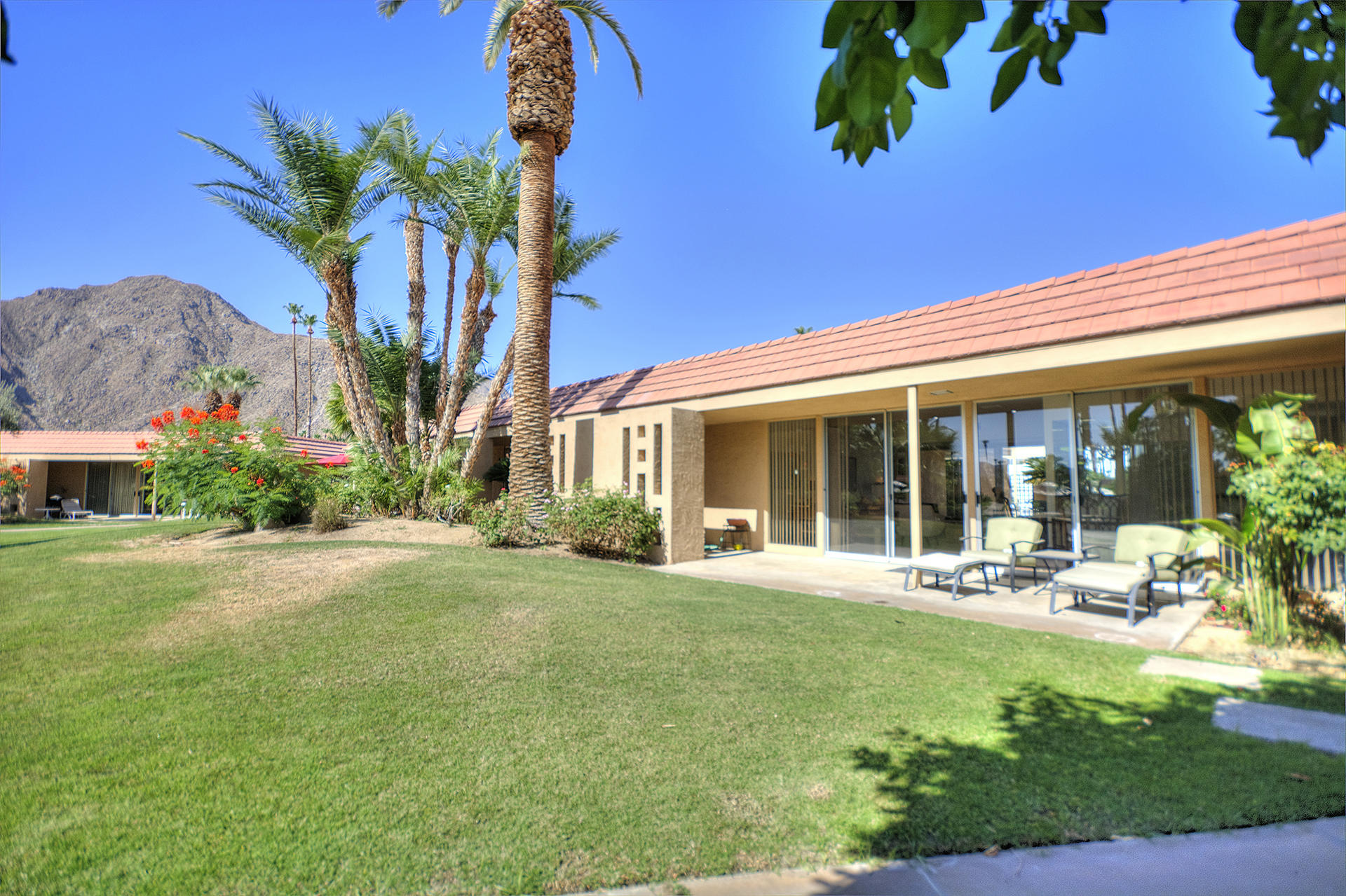 45730 Hopi Road Indian Wells, CA 92210 - Photo 1 of 42 a front view of house with yard and green space