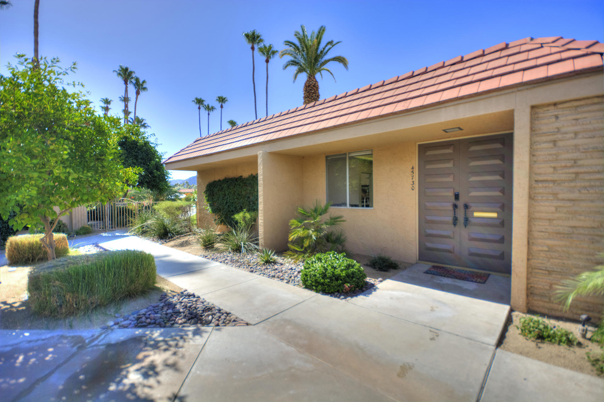 45730 Hopi Road Indian Wells, CA 92210 - Photo 2 of 42 a front view of a house with garden