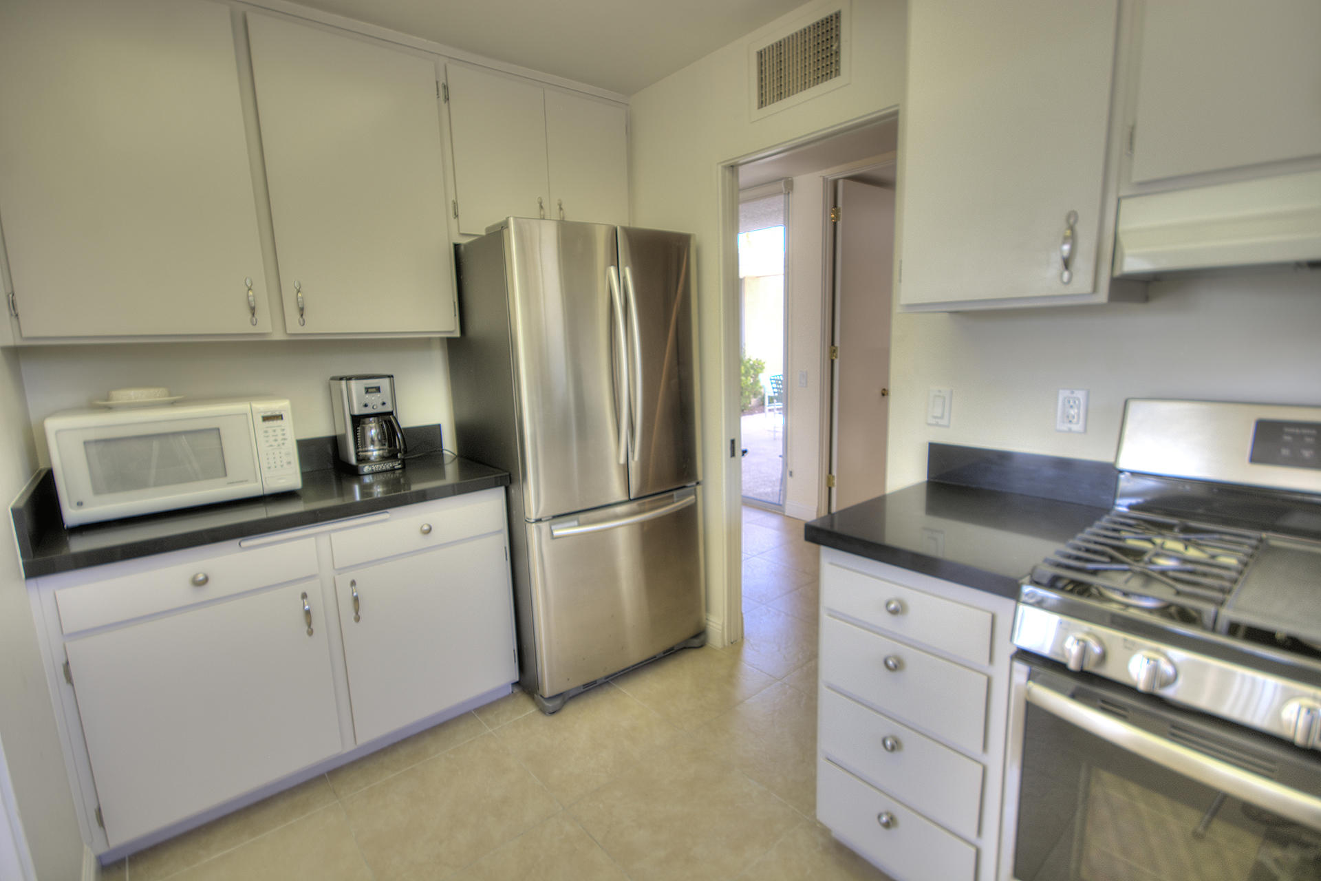 45730 Hopi Road Indian Wells, CA 92210 - Photo 11 of 42 a kitchen with appliances a sink and cabinets