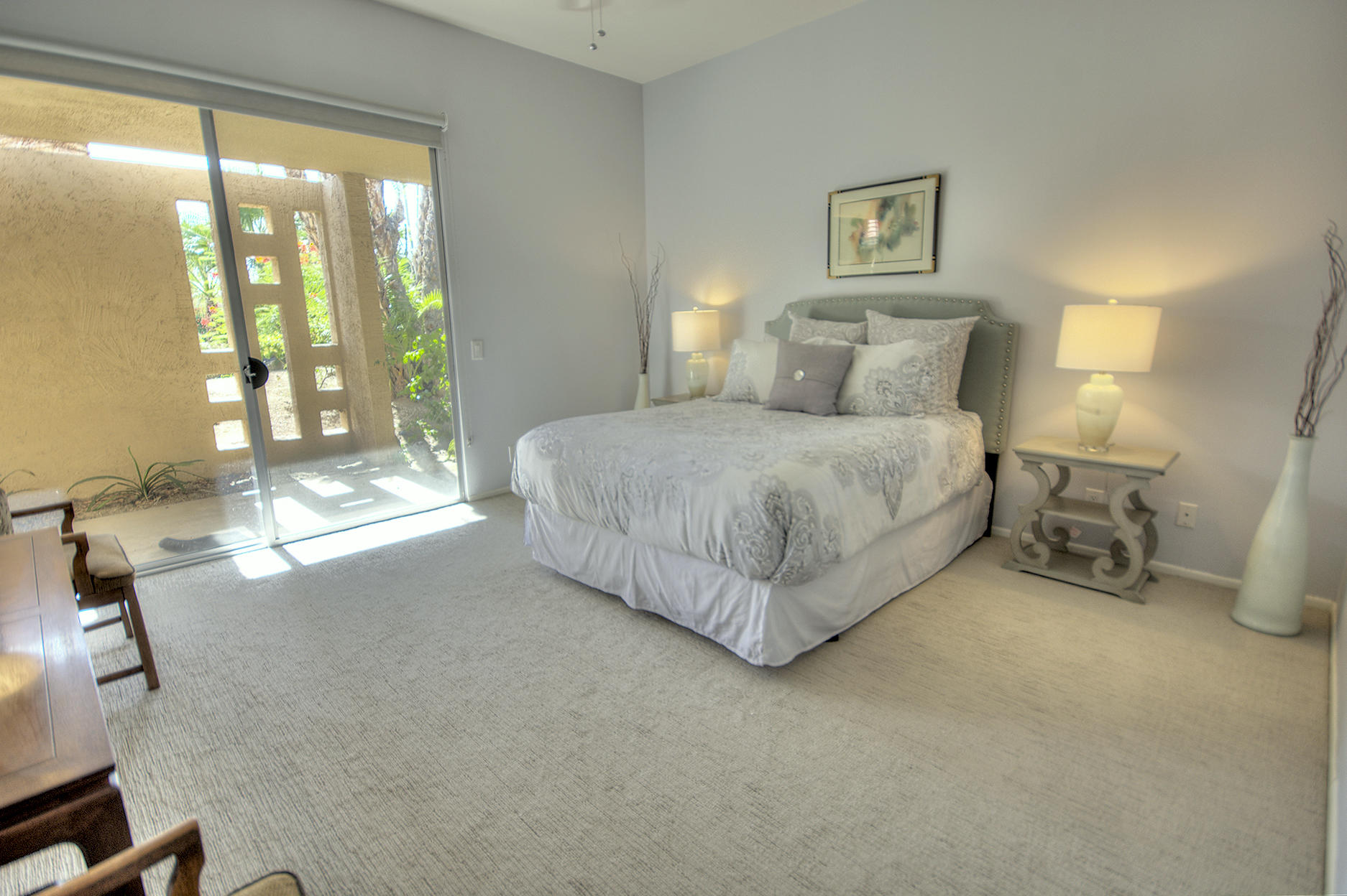45730 Hopi Road Indian Wells, CA 92210 - Photo 17 of 42 a spacious bedroom with a bed and a large window