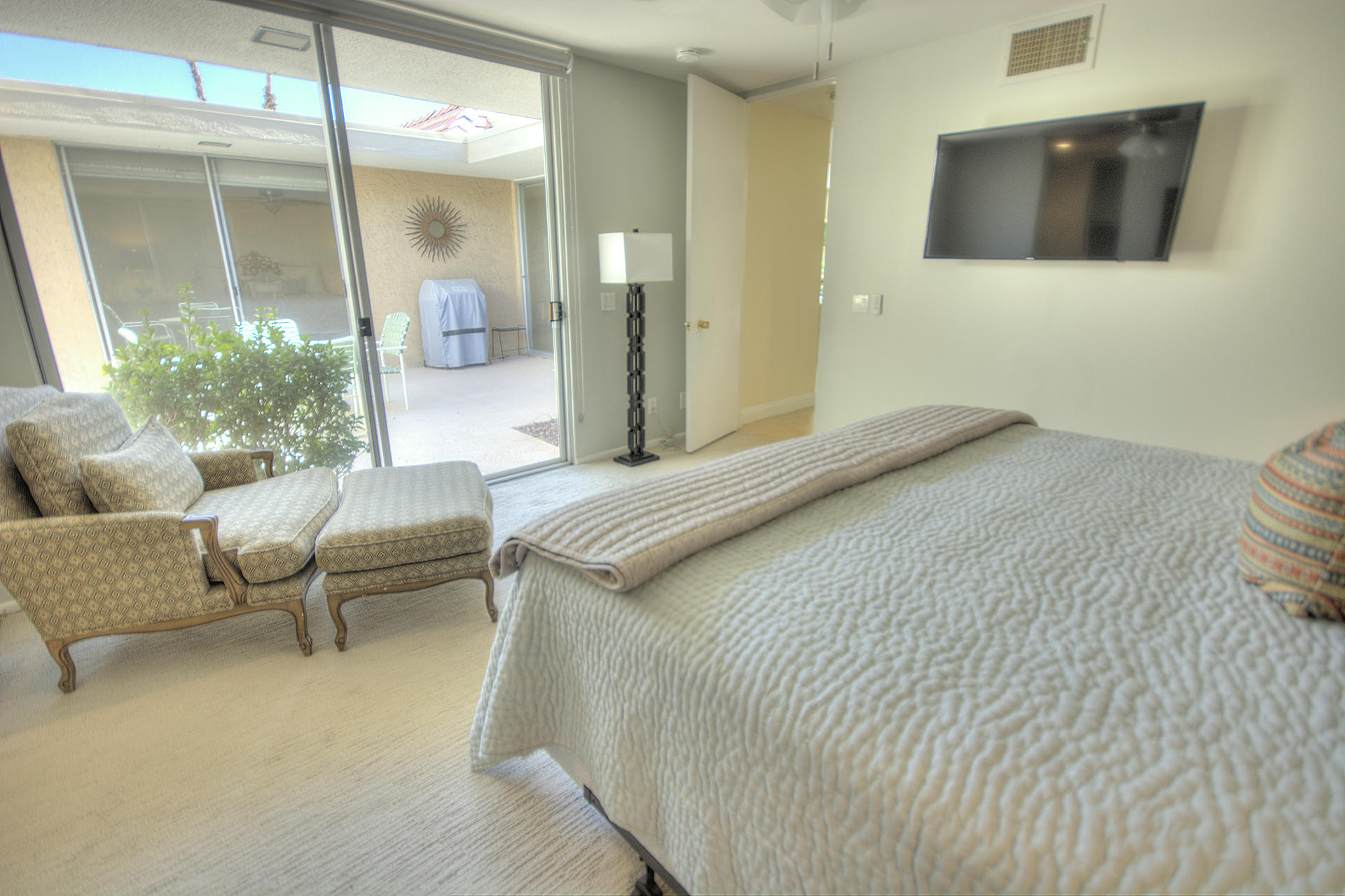 45730 Hopi Road Indian Wells, CA 92210 - Photo 24 of 42 a bedroom with a bed and glass window