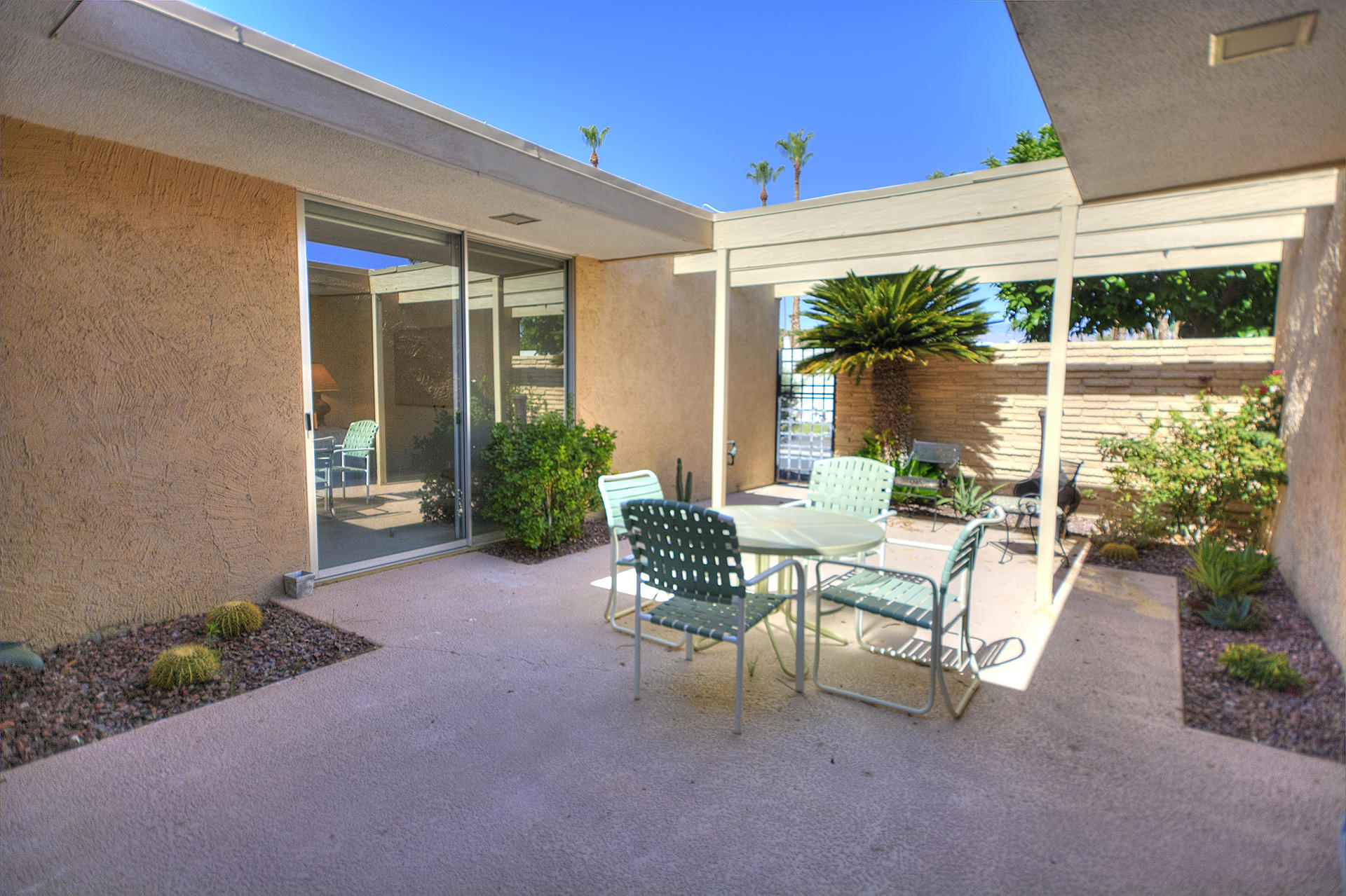 45730 Hopi Road Indian Wells, CA 92210 - Photo 29 of 42 a view of a patio with table and chairs and potted plants