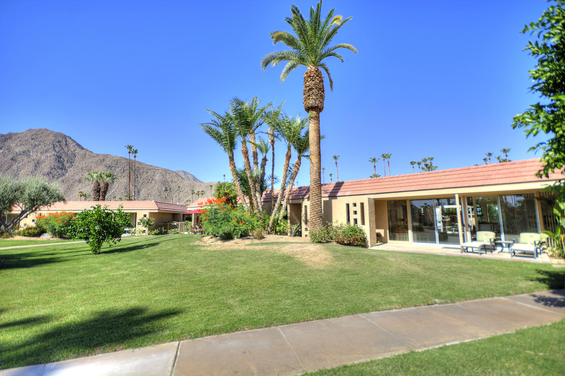 45730 Hopi Road Indian Wells, CA 92210 - Photo 33 of 42 a front view of a house with a yard and potted plants