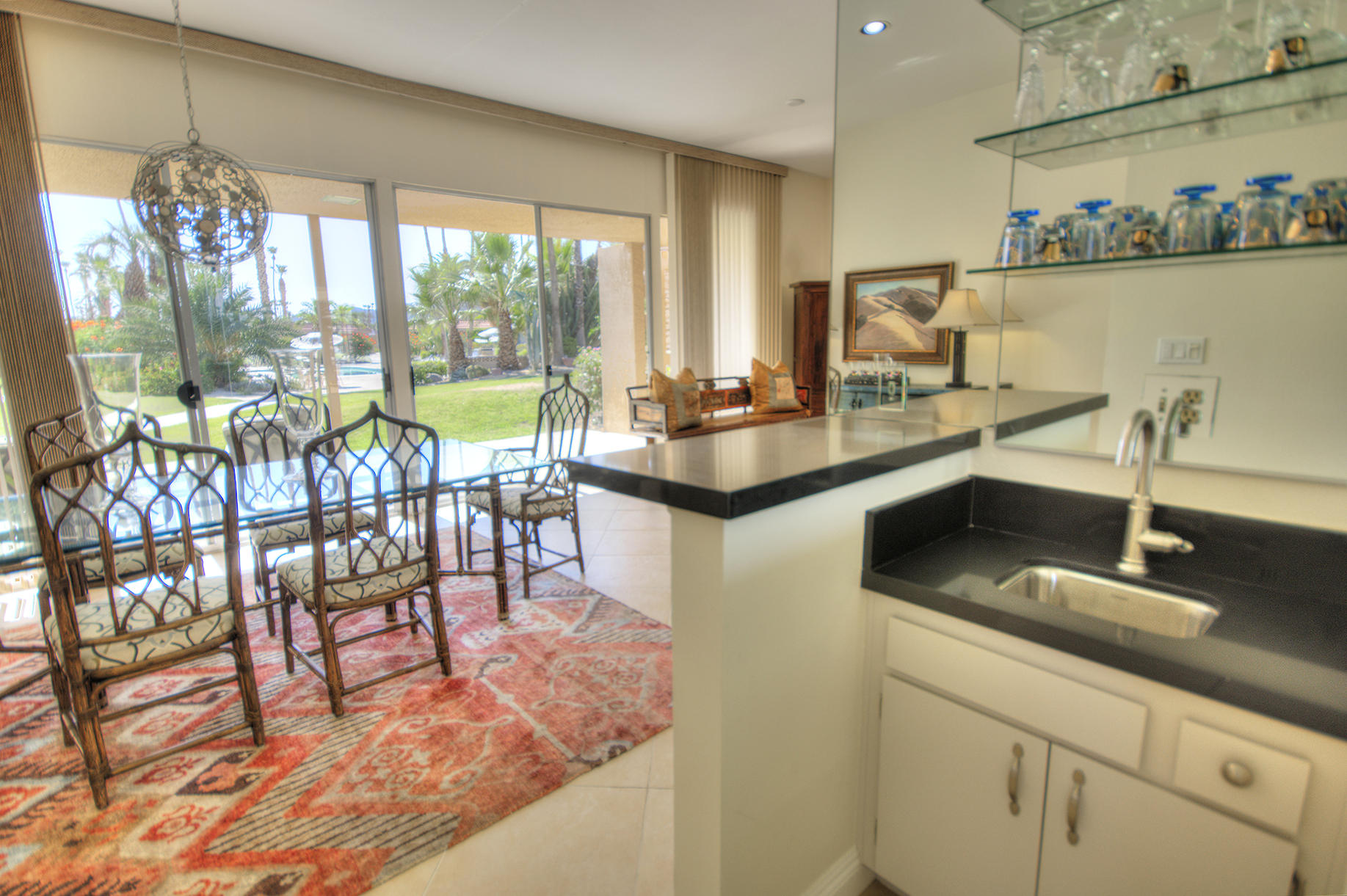 45730 Hopi Road Indian Wells, CA 92210 - Photo 9 of 42 a kitchen with a dining table chairs and large window