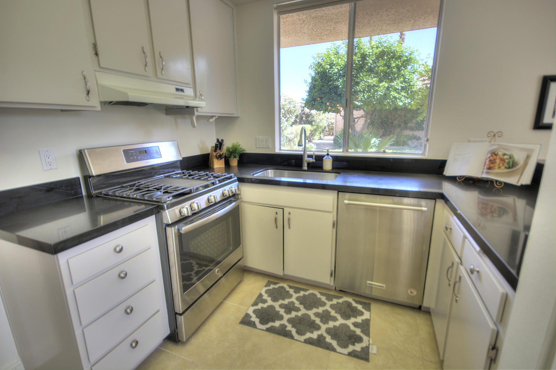 45730 Hopi Road Indian Wells, CA 92210 - Photo 10 of 42 a kitchen with stainless steel appliances granite countertop a sink stove and cabinets