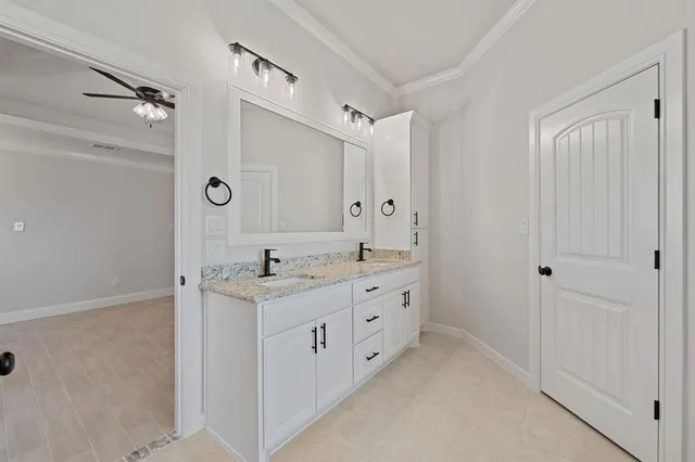 a bathroom with a granite countertop sink a mirror and a shower