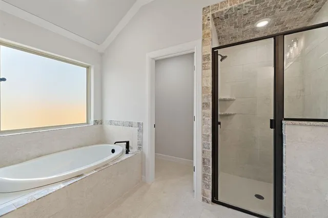a bathroom with a bathtub and a shower