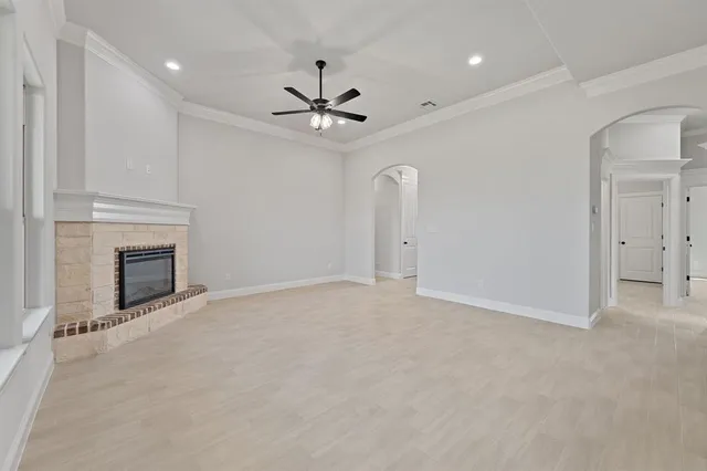 a view of an empty room with a fireplace