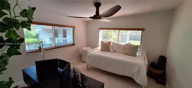 a bedroom with a bed and a potted plant