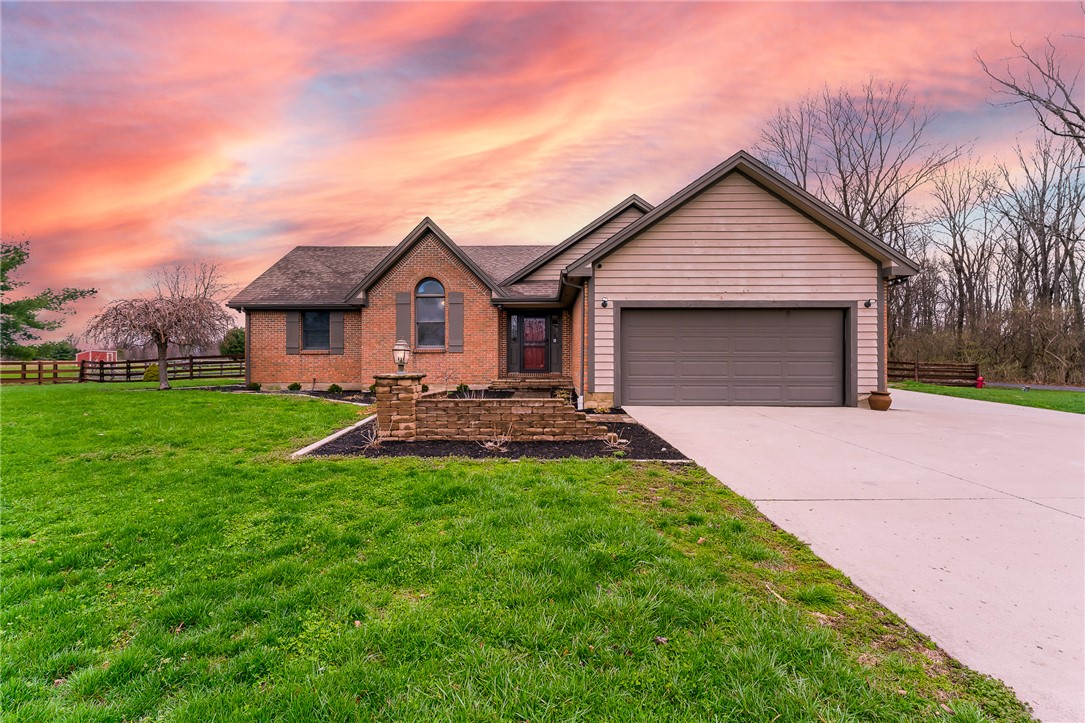 7400 Cook-Jones Road Waynesville, OH 45068 - Photo 2 of 72 This charming home features a mix of brick and siding, a welcoming entryway, and a convenient attached garage.