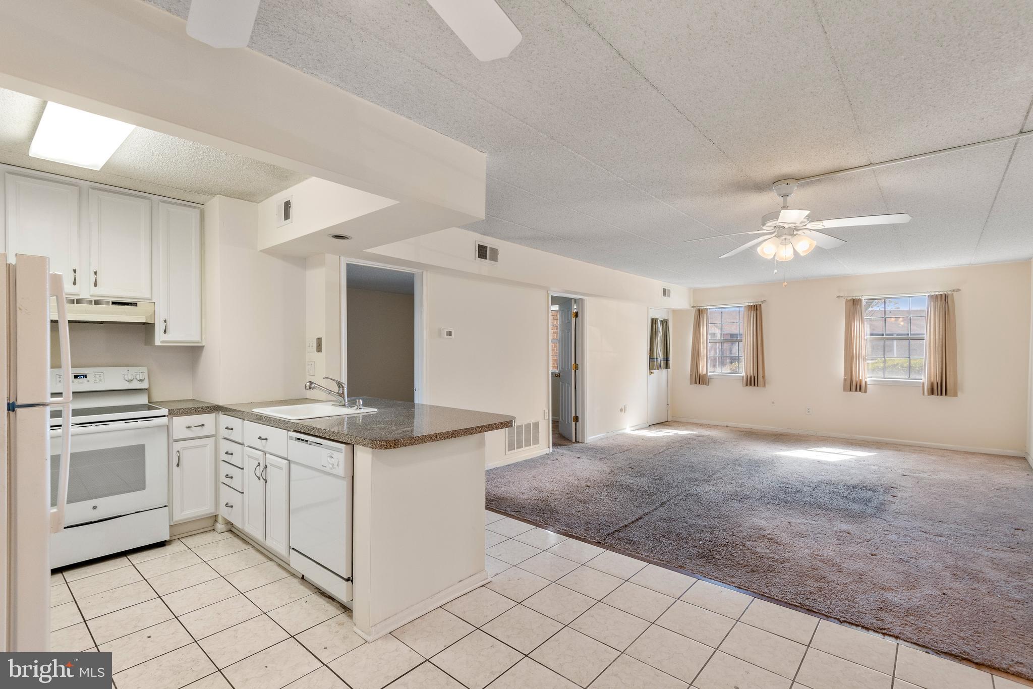 130 Riversedge Drive, Unit CONDO 130 Norristown, PA 19403 - Photo 11 of 20 a kitchen with stainless steel appliances granite countertop a stove and a sink