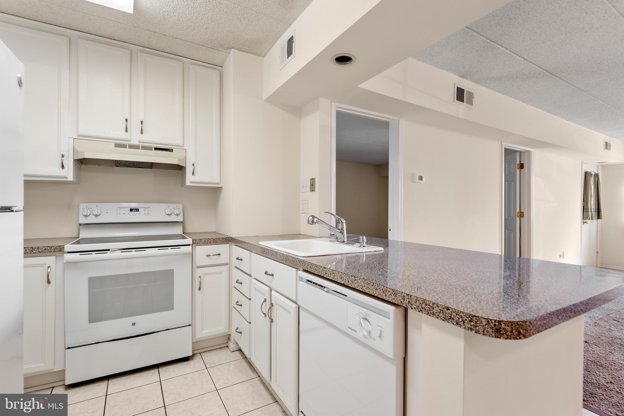 130 Riversedge Drive, Unit CONDO 130 Norristown, PA 19403 - Photo 12 of 20 a kitchen with stainless steel appliances granite countertop a sink stove and cabinets